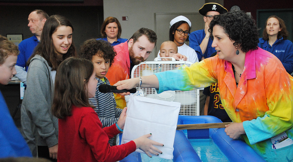 A group of children engage in scientific exploration at the Great Lakes Science Center.