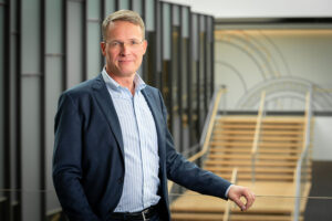 Photgraph of Andreas Roellgen, Timken executive vice president and president of engineered bearings, standing near a stairway.