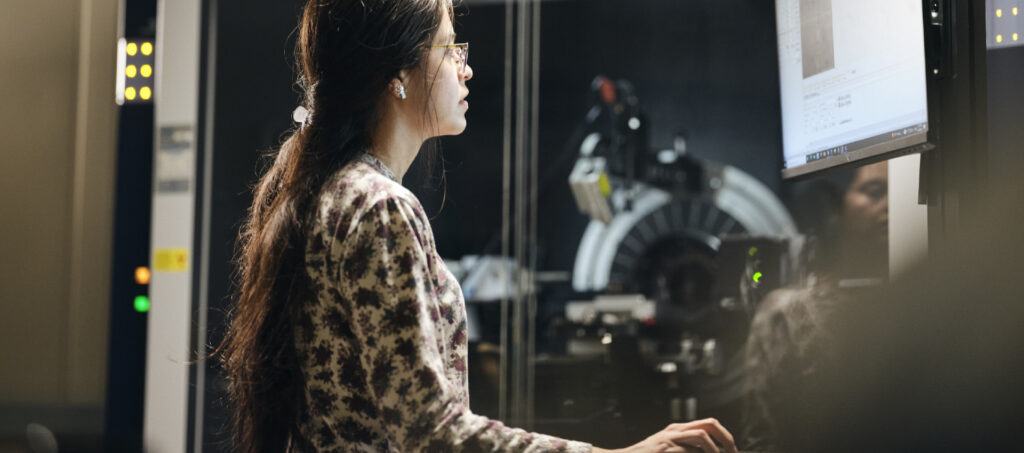 Photograph of woman scientist working at a computer workstation.