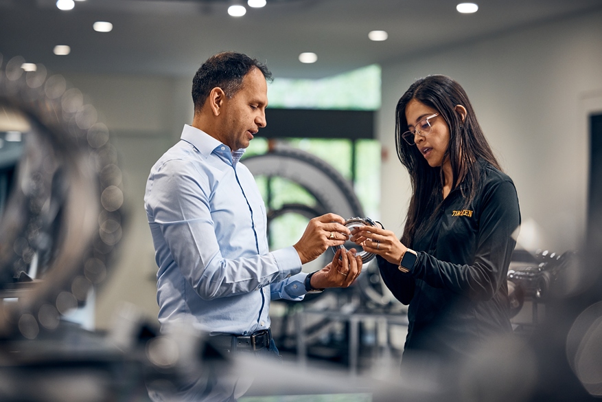 2 professionals hold a product design have a discussion