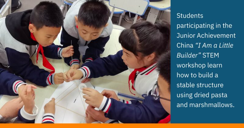 Students participating in the Junior Achievement China “I Am a Little Builder” STEM workshop learn how to build a stable structure using dried pasta and marshmallows.